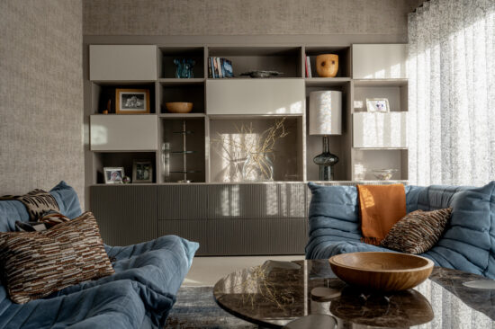 Snug seating area with dark ribbed joinery, a marble coffee table and a patterned rug
